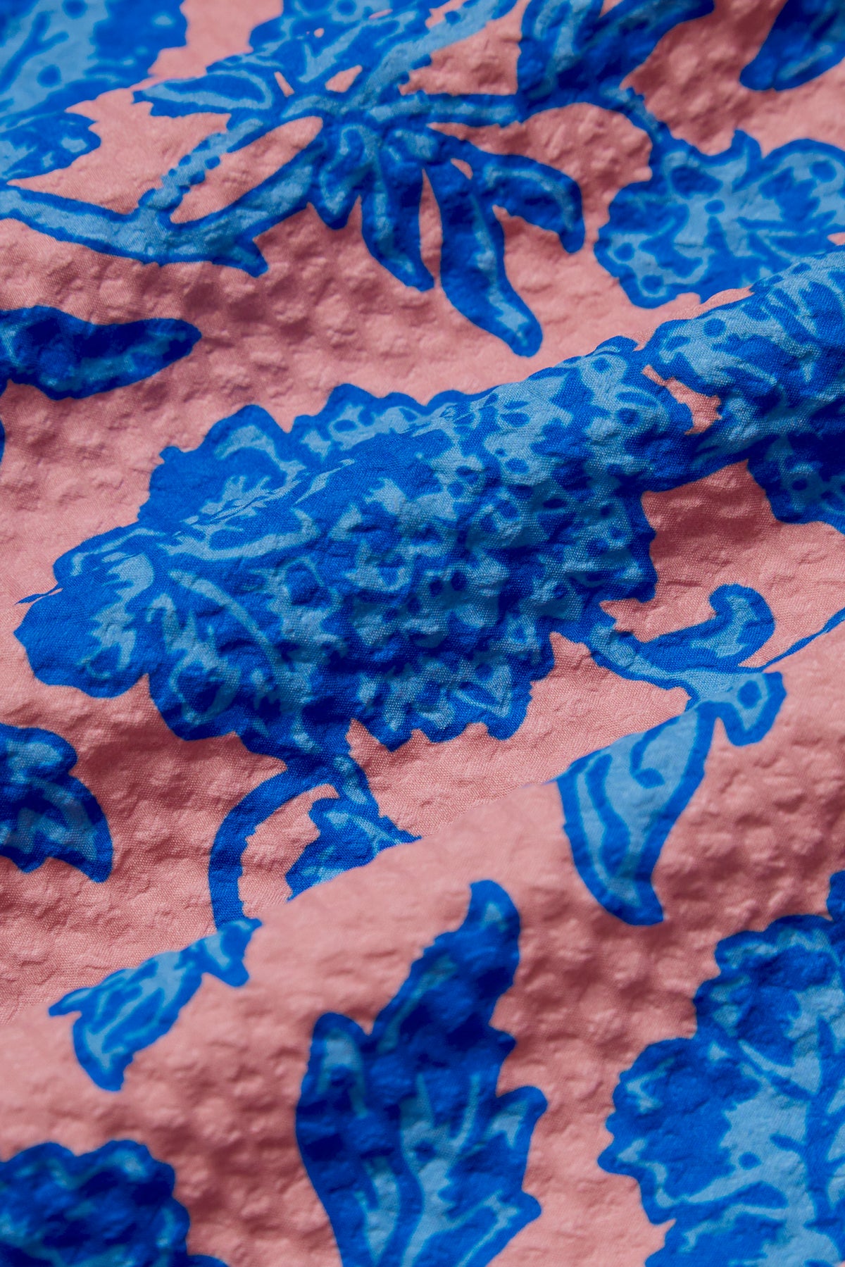 CORAL FLOWER SWIM TRUNKS